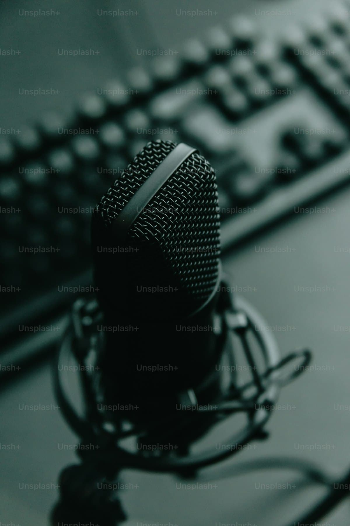 Professional microphone on a desk next to a keyboard, representing voice dictation for productivity